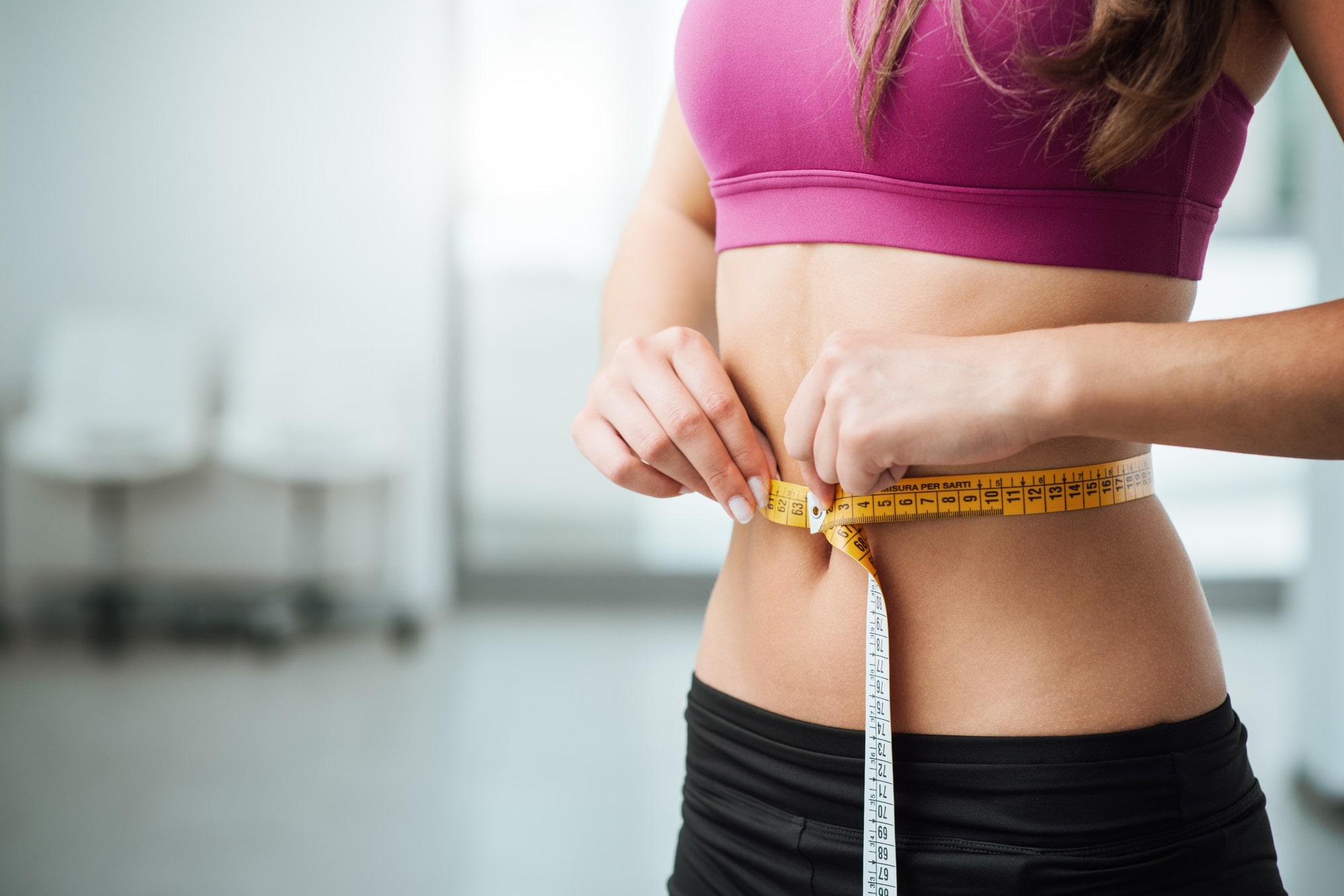 Woman Measuring Her Waist Line