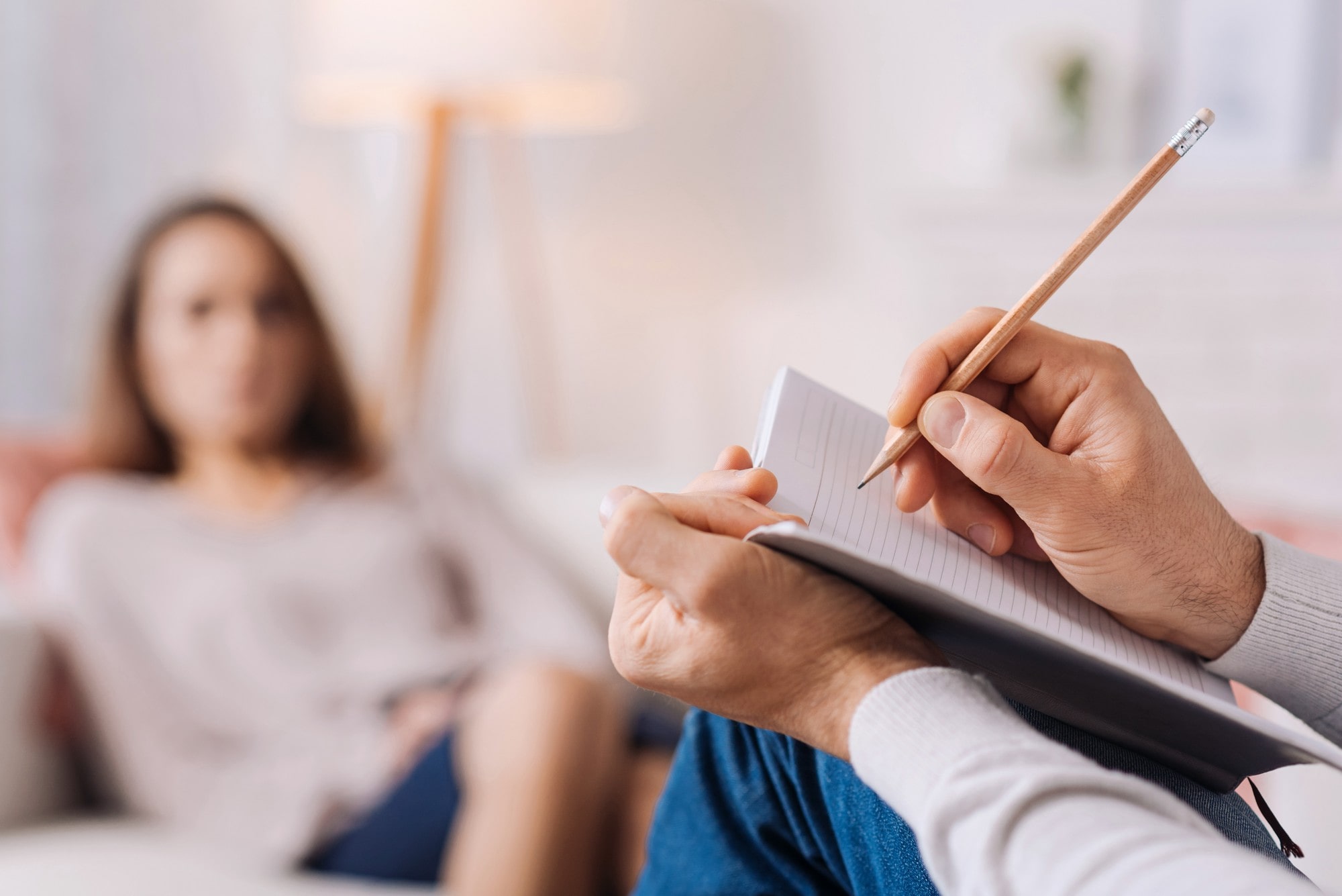 Therapist Taking Notes During Consultation